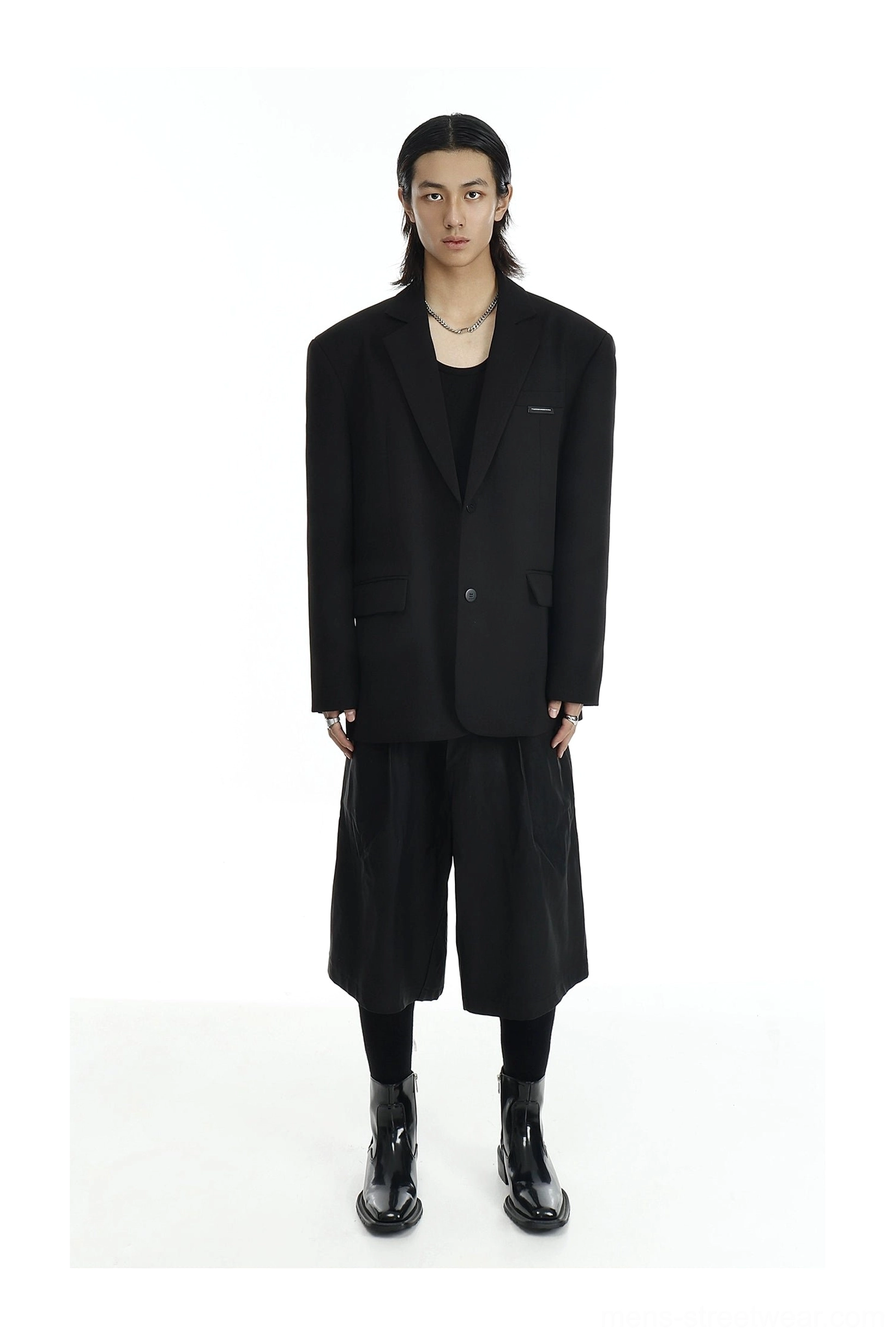 Black two-button relaxed-fit blazer layered over a black tank top with cropped wide-leg culottes
