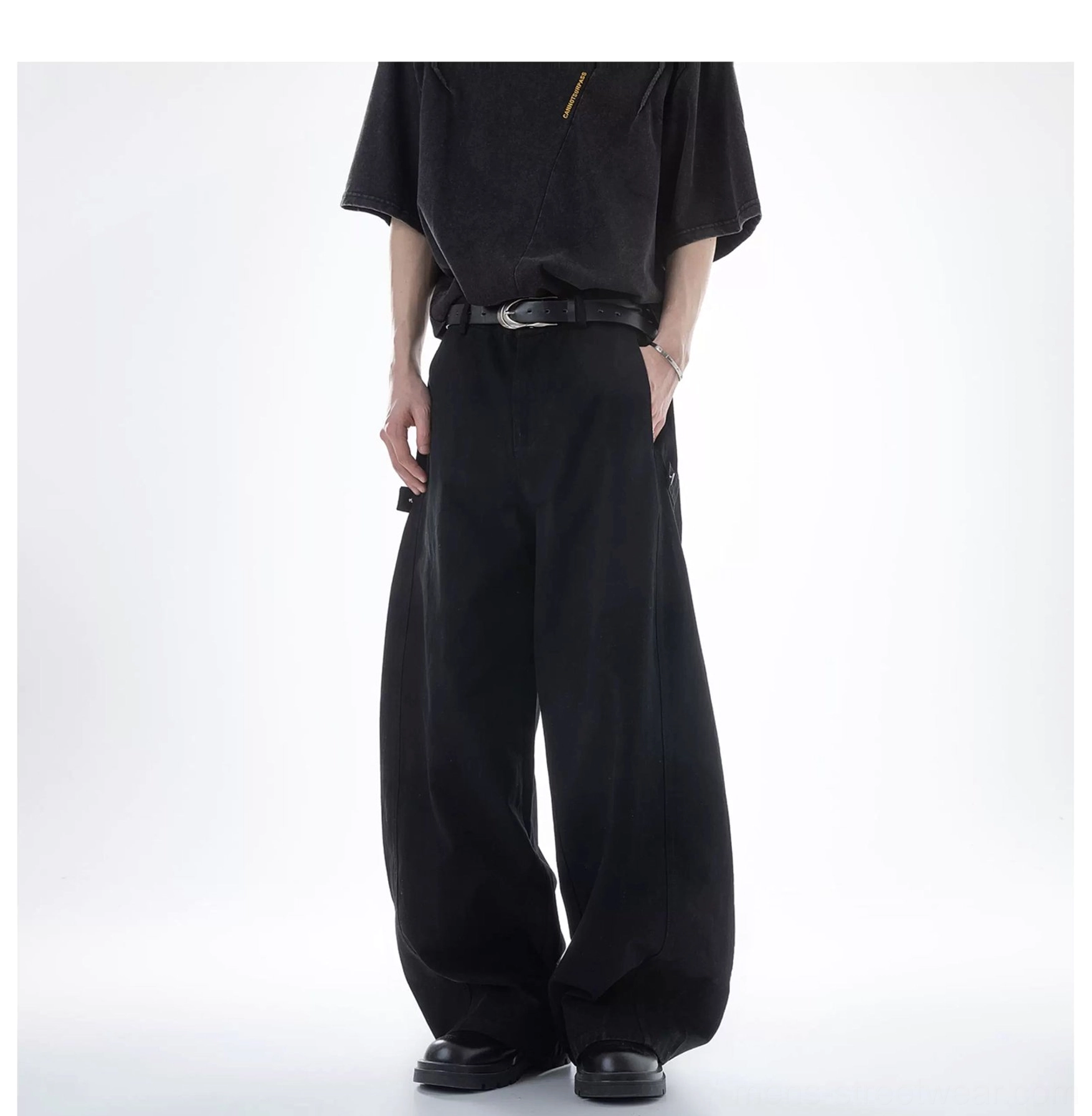 Black ultra wide-leg cargo pants styled with a distressed black tee, black belt, oversized wide-leg fit, and functional side cargo pockets in a streetwear look