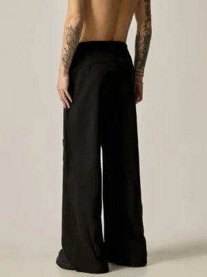 Black ultra-wide leg tailored trousers rear full body view showing clean back seams and relaxed wide leg streetwear fit