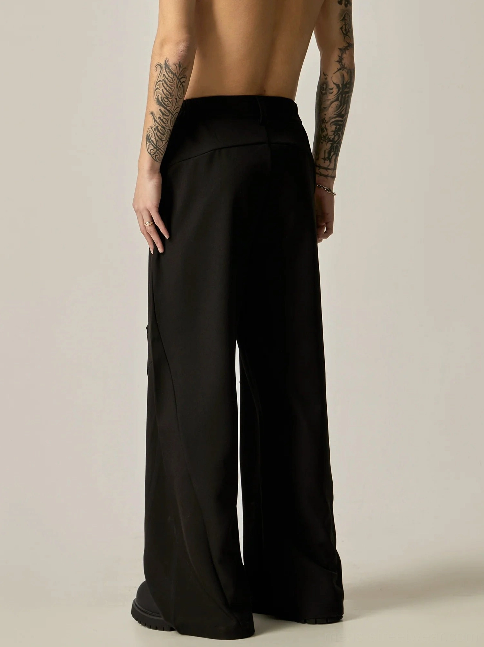 Black ultra-wide leg tailored trousers rear full body view showing clean back seams and relaxed wide leg streetwear fit