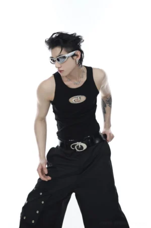 Three-quarter view of black unisex sleeveless logo vest tee styled with wide-leg cargo pants, utility belt, and monochrome Korean streetwear outfit