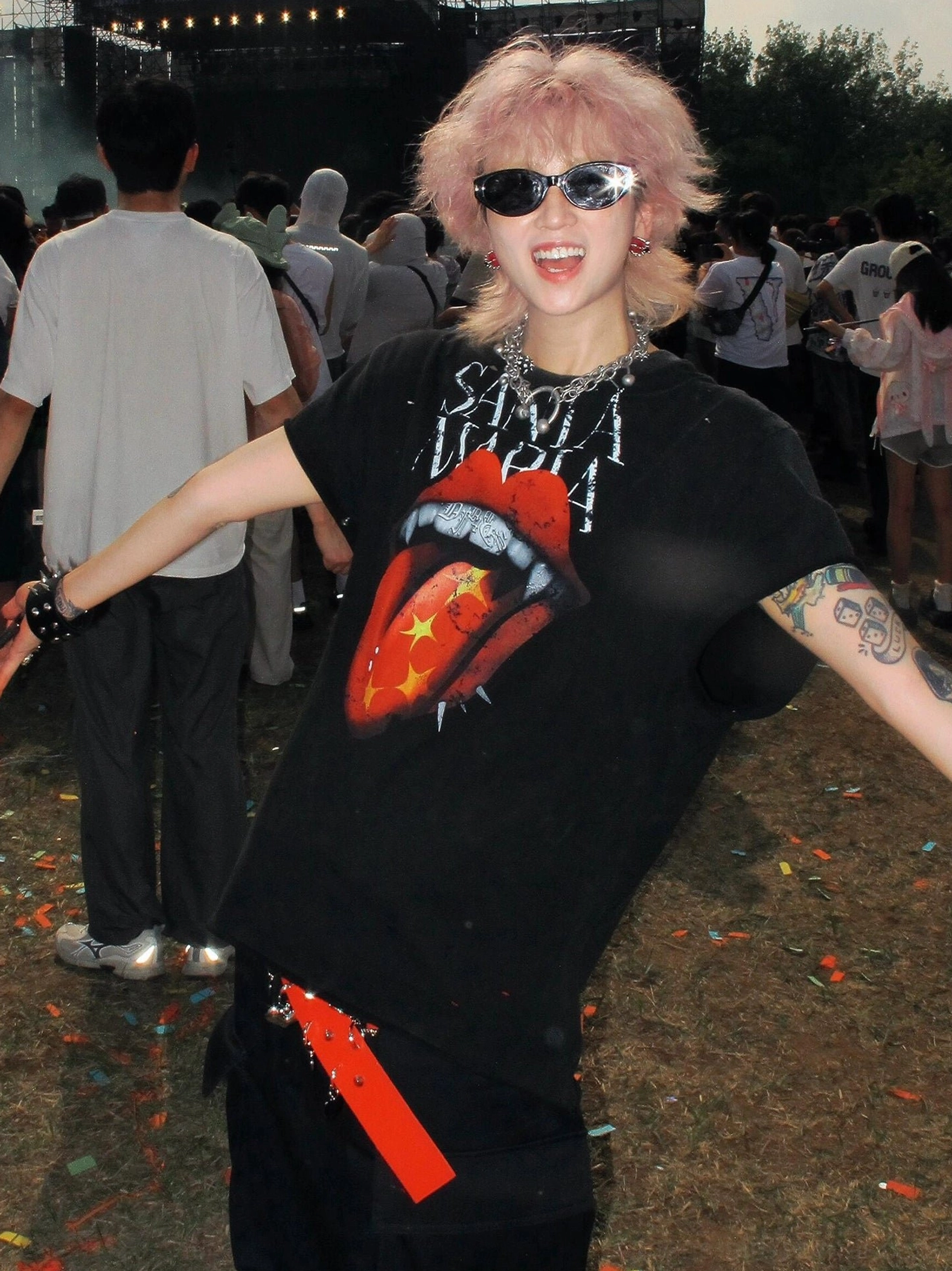 Festival streetwear outfit featuring a faded black vampire lips tongue graphic tee and layered silver chain necklaces