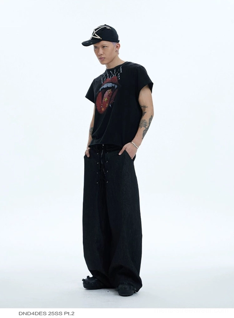 Male model wearing a black vampire tongue rock graphic tee with wide-leg cargo pants in a streetwear outfit