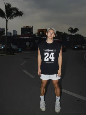 Black varsity 24 oversized sleeveless graphic muscle tee full front outfit with white shorts at night