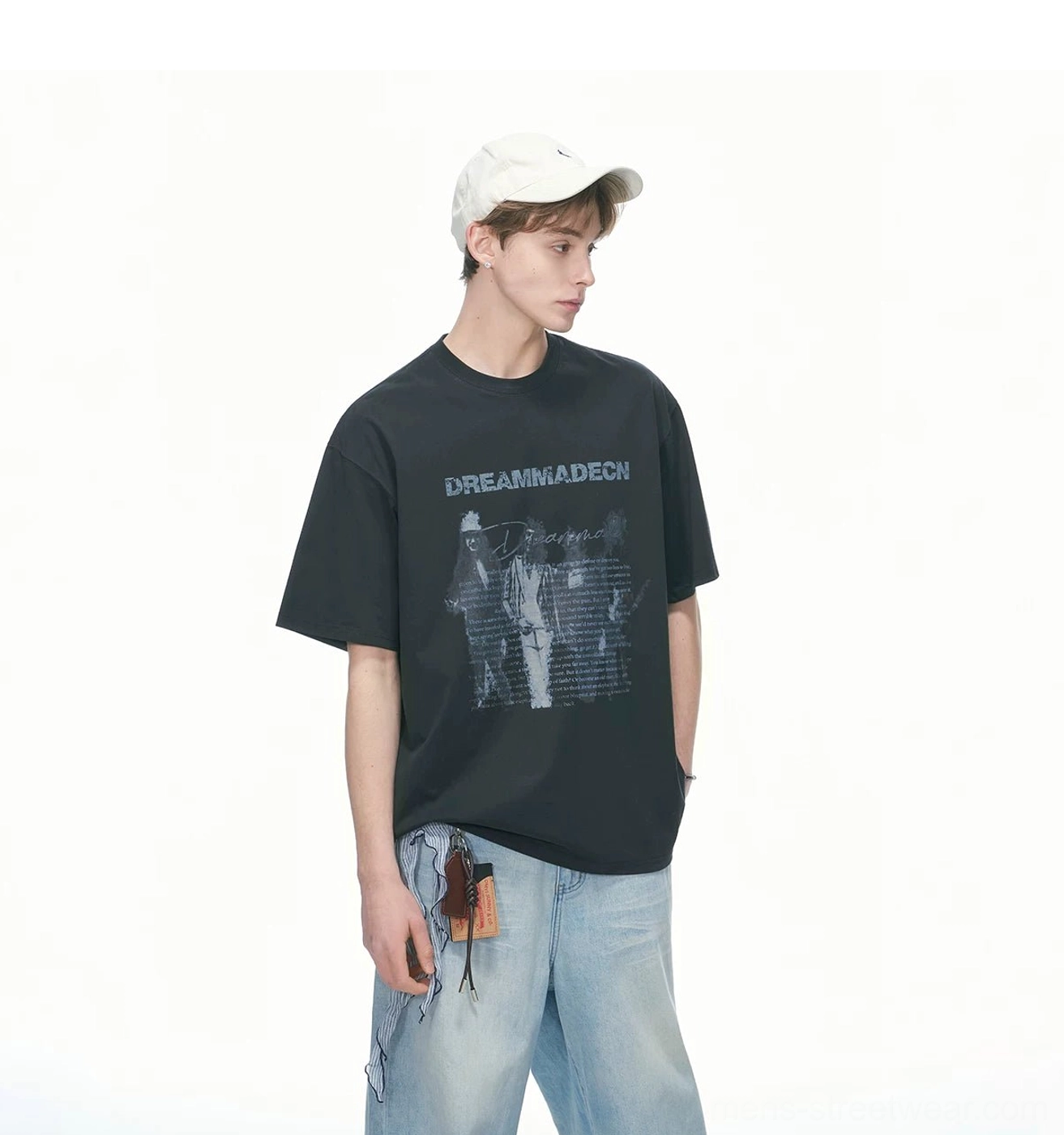 Black vintage graphic oversized crew neck T-shirt styled with light wash wide leg denim and a white cap from a three quarter angle