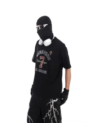 Three-quarter side view of black vintage varsity number 7 oversized T-shirt with distressed print and relaxed Korean streetwear fit