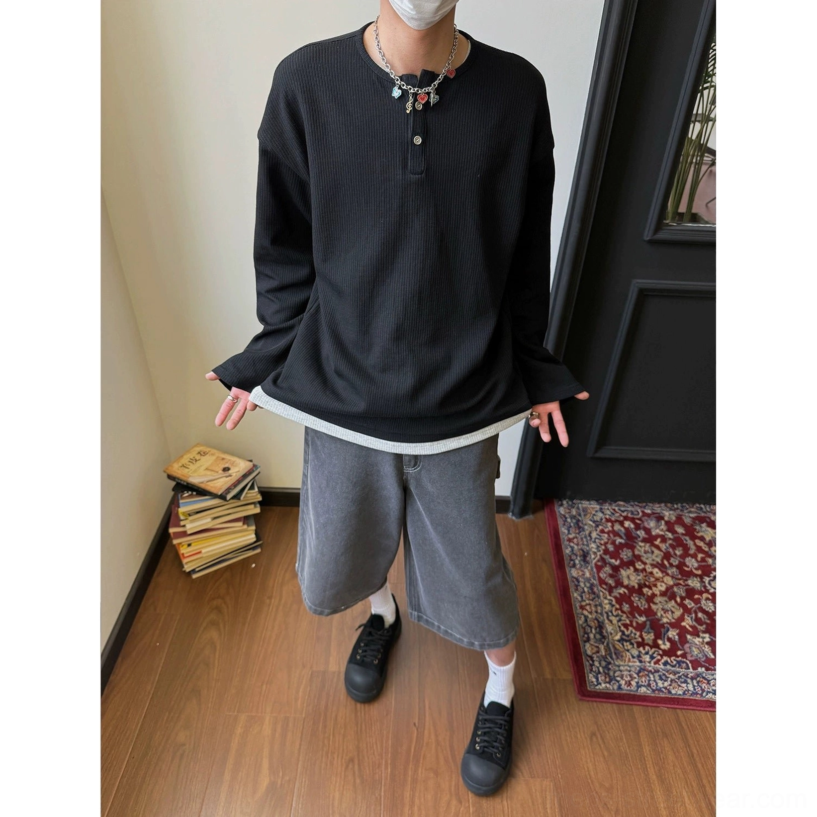 Black waffle knit Henley long-sleeve shirt with relaxed fit and versatile modern streetwear styling