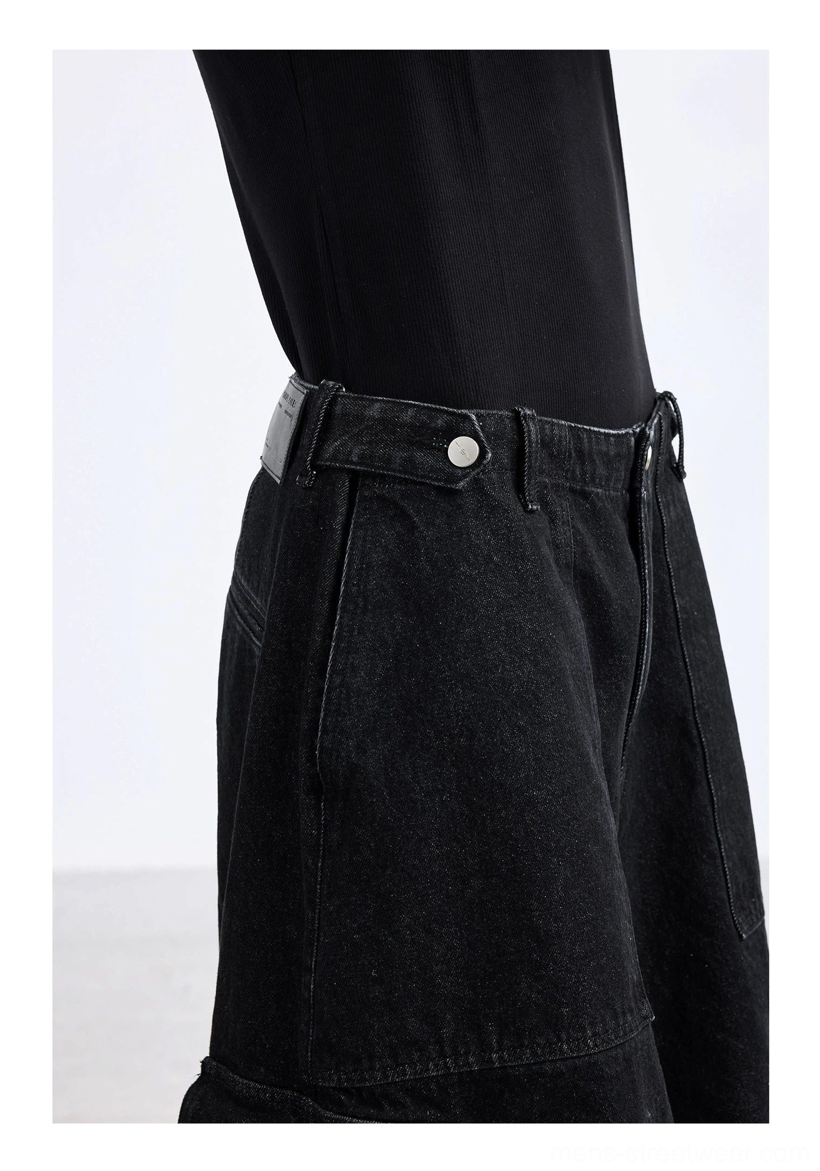Black washed denim cargo capri shorts waist close-up featuring belt loops metal button waist tab zipper fly and utility denim construction