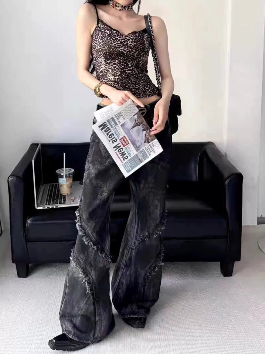 Front view of black washed distressed flared jeans featuring diagonal frayed seam details, wide-leg flare silhouette, and vintage streetwear styling