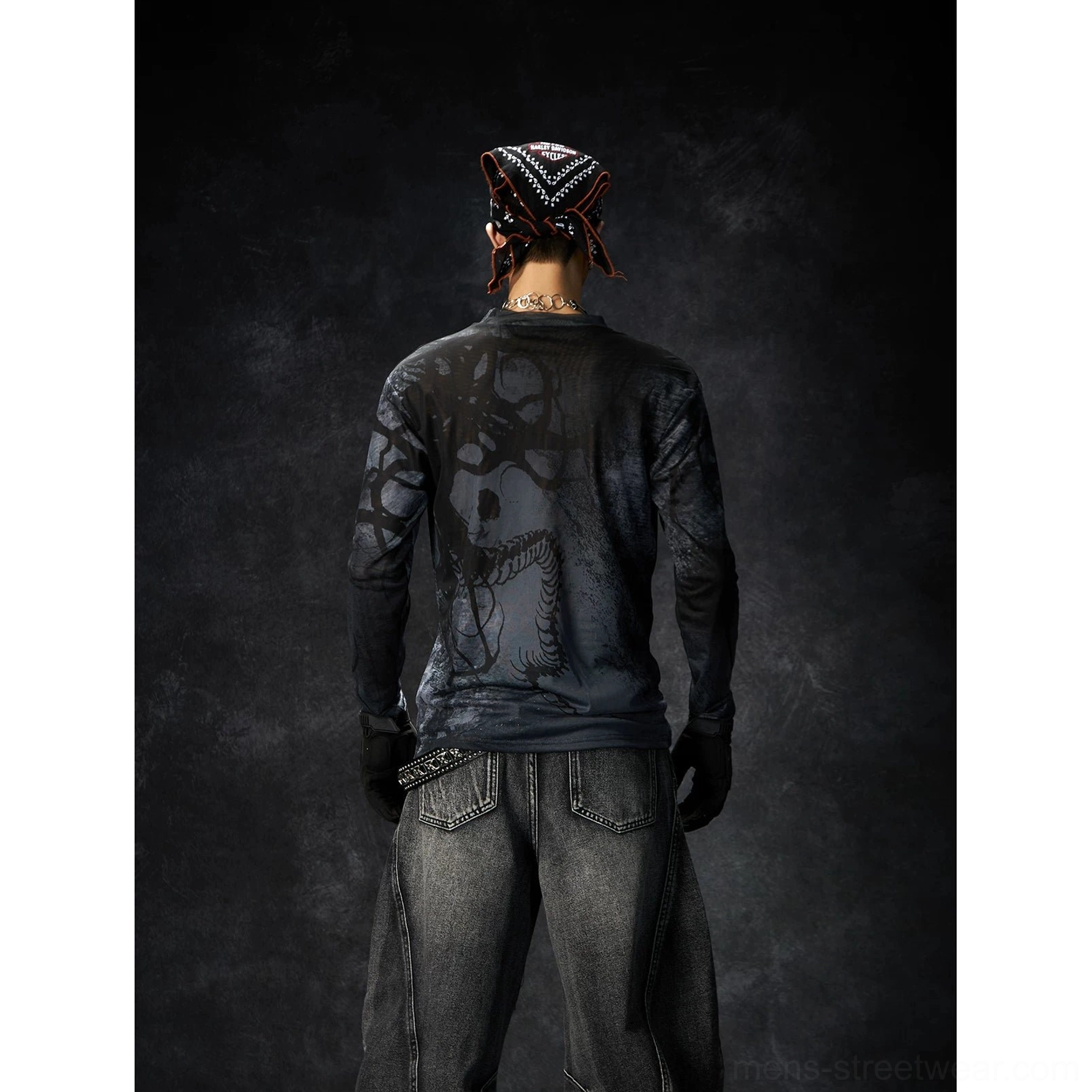 Back view of a black washed grunge long sleeve streetwear tee with graphic print styled with distressed baggy jeans