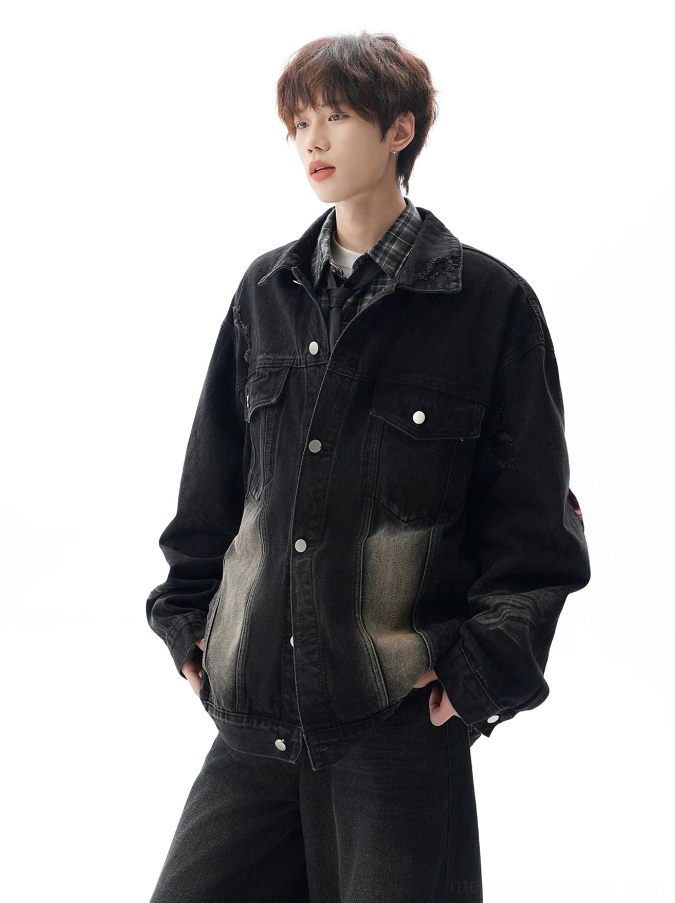 Black washed oversized denim jacket shown from a side angle with faded lower torso, flap pockets, and loose casual streetwear fit