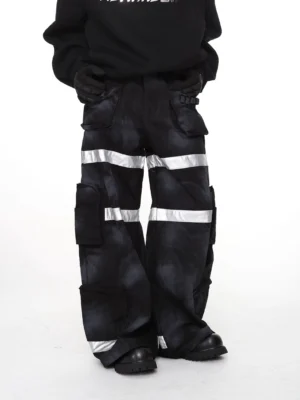 Black washed tie-dye reflective wide-leg cargo pants styled with oversized black hoodie work gloves and rugged boots