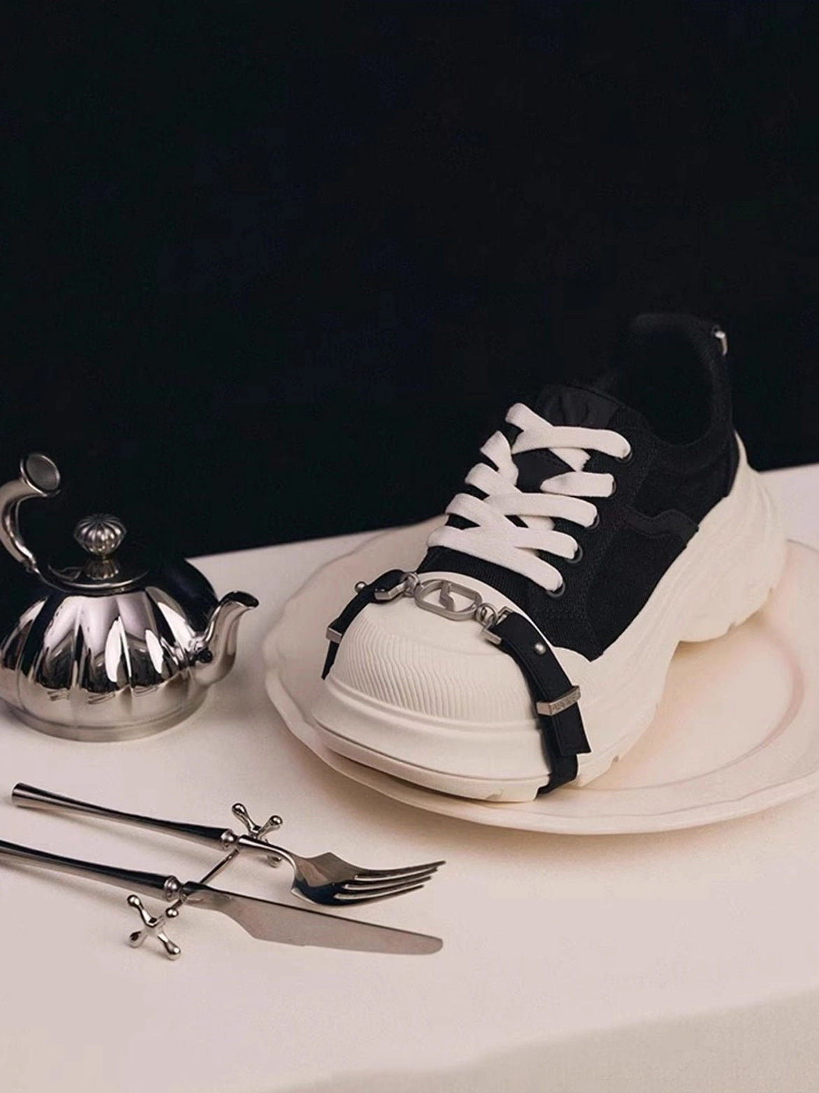 Single black and white buckle platform canvas sneaker top-down view showing silver buckle strap, side profile, and thick platform sole