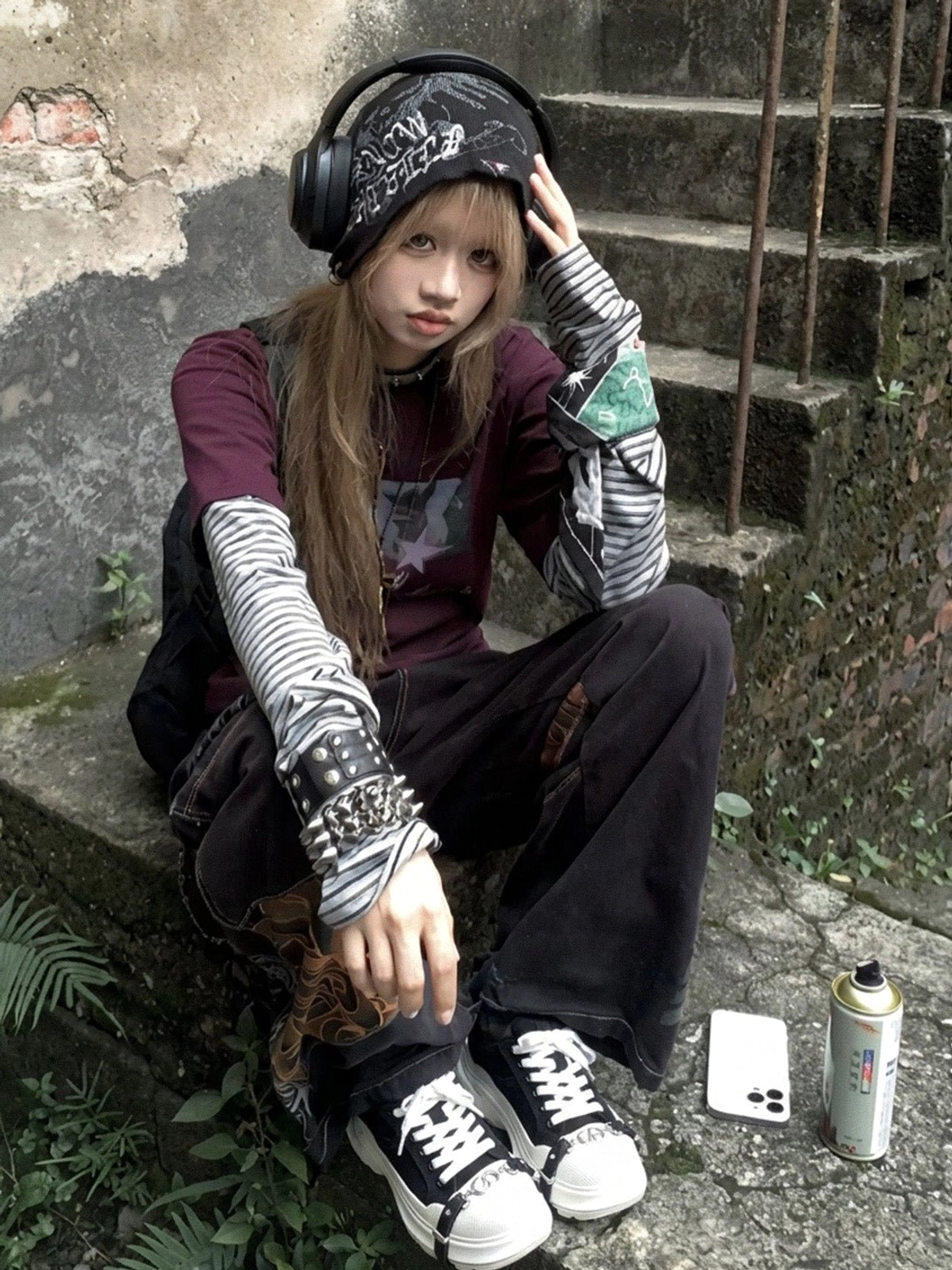 Female Y2K streetwear model wearing black and white buckle platform canvas sneakers with cargo pants and layered tops