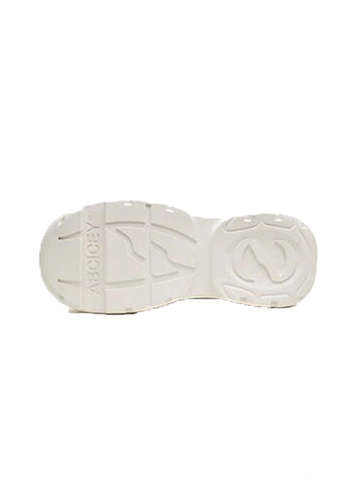 Textured outsole of black and white platform canvas sneakers showing anti-slip tread pattern and printed sole lettering