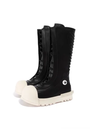 Pair of black and white lace-up mid-calf platform boots with oversized off-white toe caps and sculpted platform outsoles front view