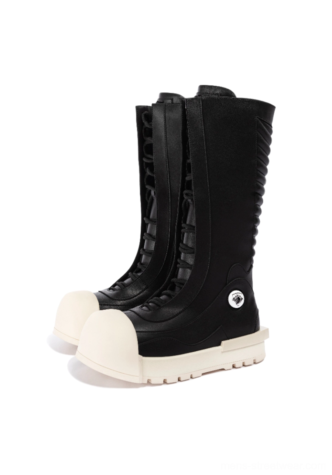 Pair of black and white lace-up mid-calf platform boots with oversized off-white toe caps and sculpted platform outsoles front view