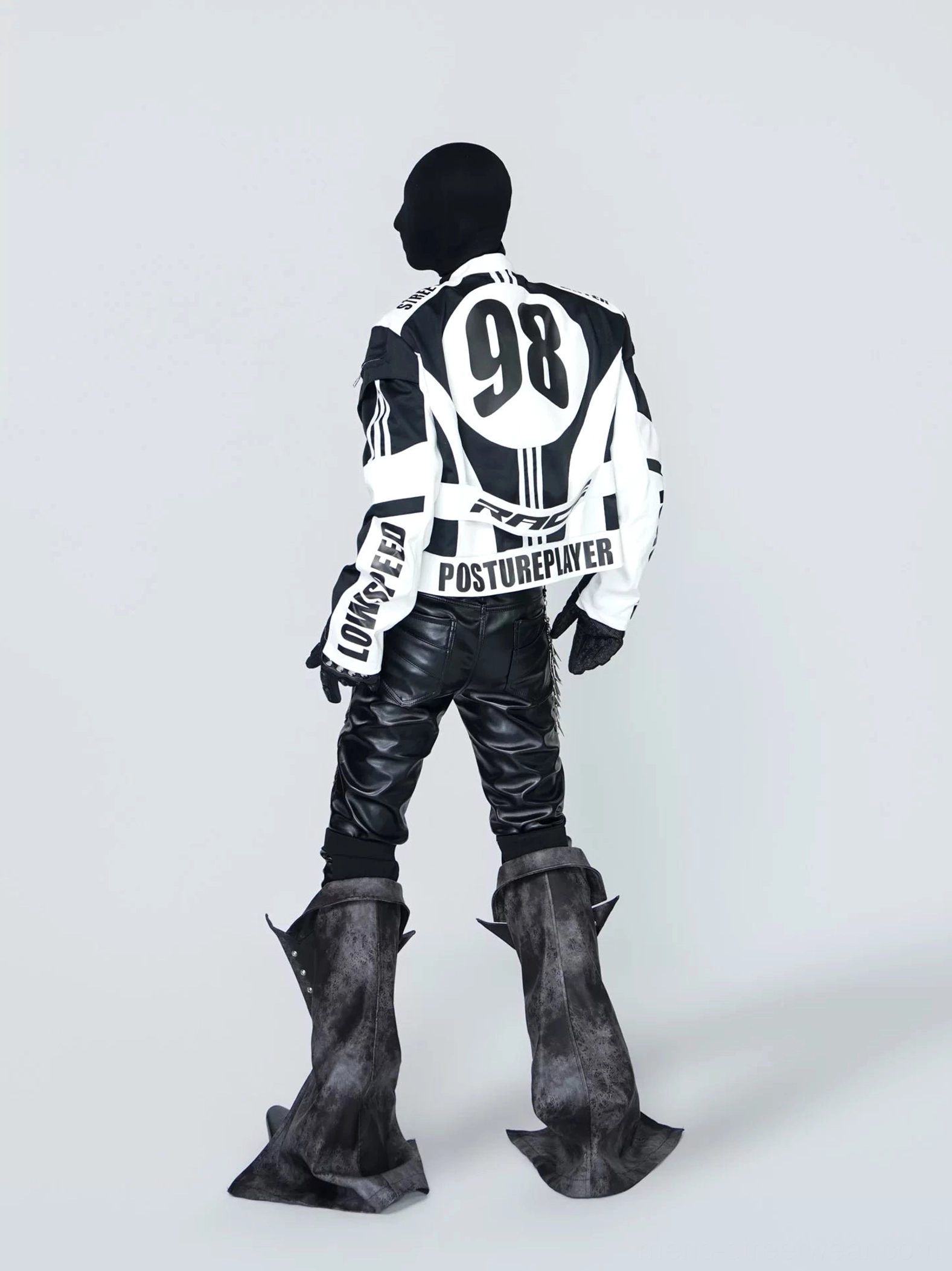 Back view of black and white cropped graphic racing jacket featuring large 98 number print, lettering and racing stripe details