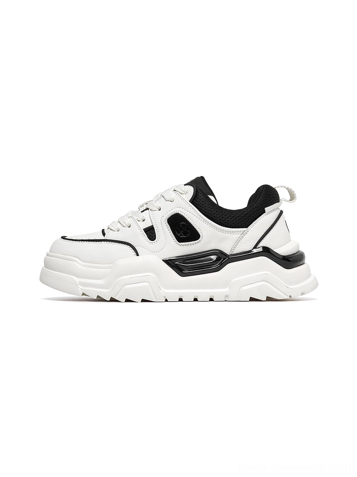 Black and white chunky platform sneakers with geometric cutout panels displayed flat from side angle showing complete shoe profile and lug sole design streetwear