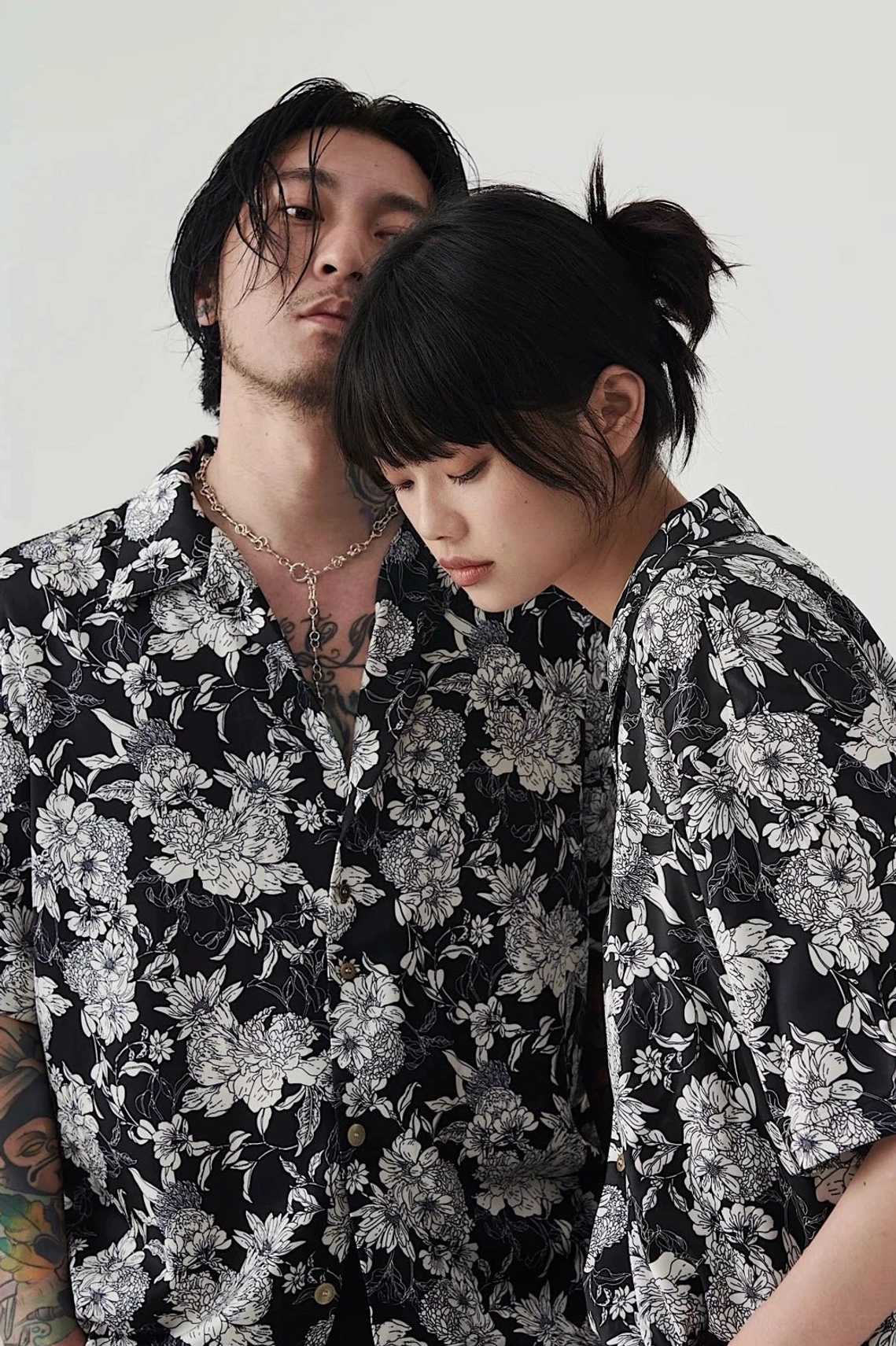 Close up view of black and white floral Hawaiian shirt button front and detailed peony print
