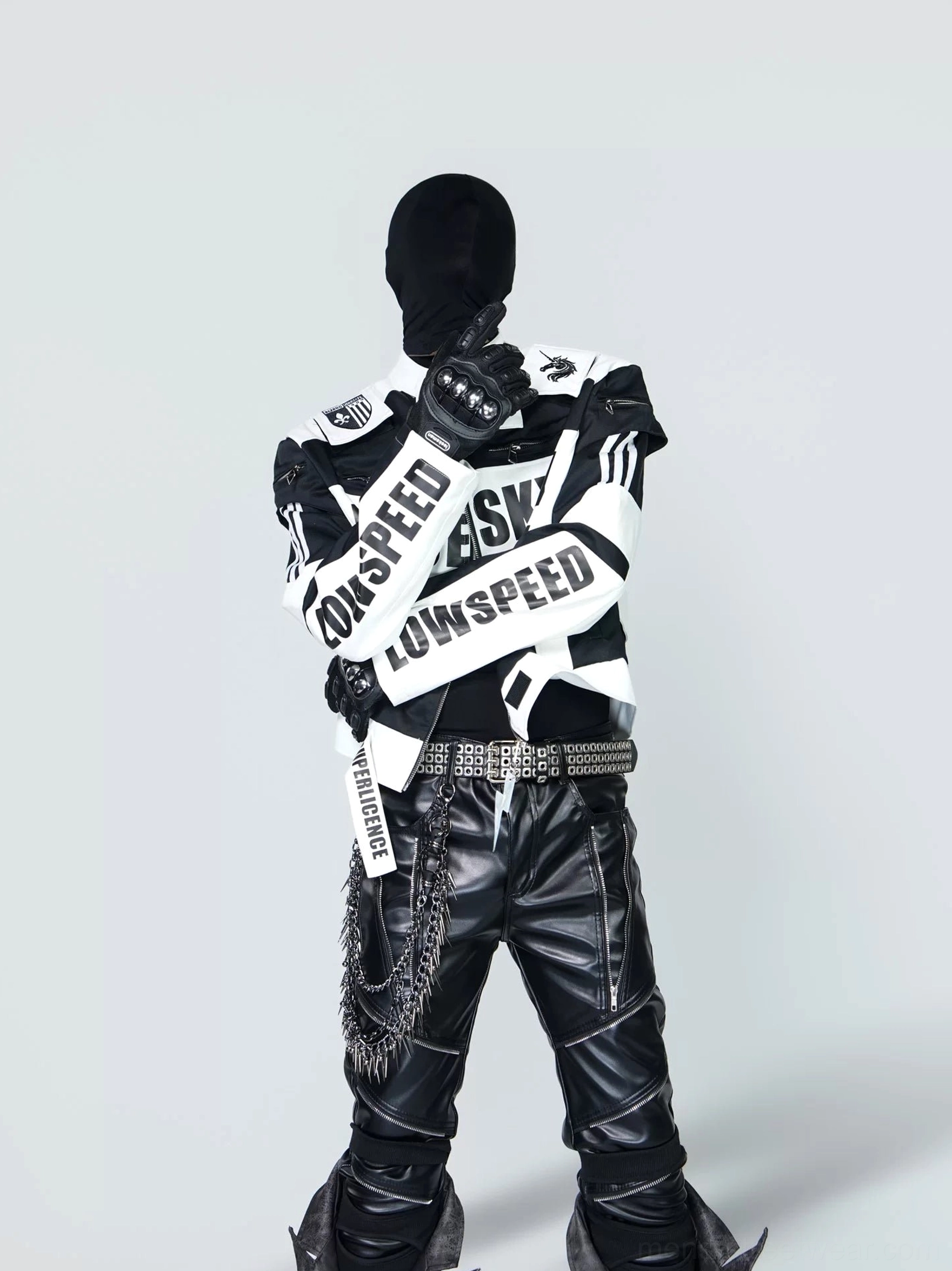 Black and white graphic racing jacket three-quarter front view showing contrast sleeve lettering, cropped moto silhouette and zip pockets