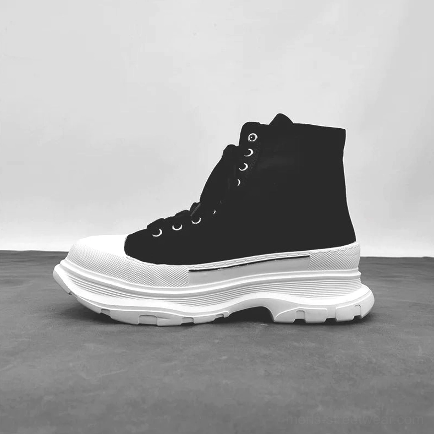 Black and white high-top platform canvas sneaker with ankle collar white toe cap chunky sole and lace-up front