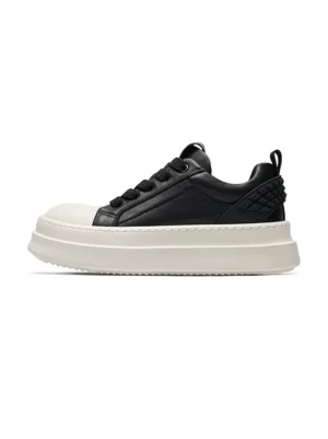 Black and white leather platform sneakers in left side profile with a thick white flatform sole and quilted heel panel