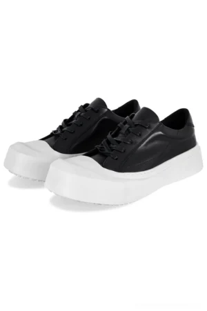 Black and white leather toe cap platform sneakers with square toe, lace-up front, and thick white EVA sole displayed on a clean background
