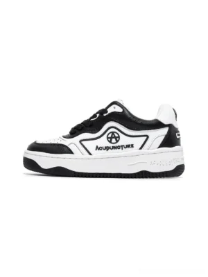 Black and white logo skate sneakers shown from the left side with layered rubber platform sole and contrast streetwear panels