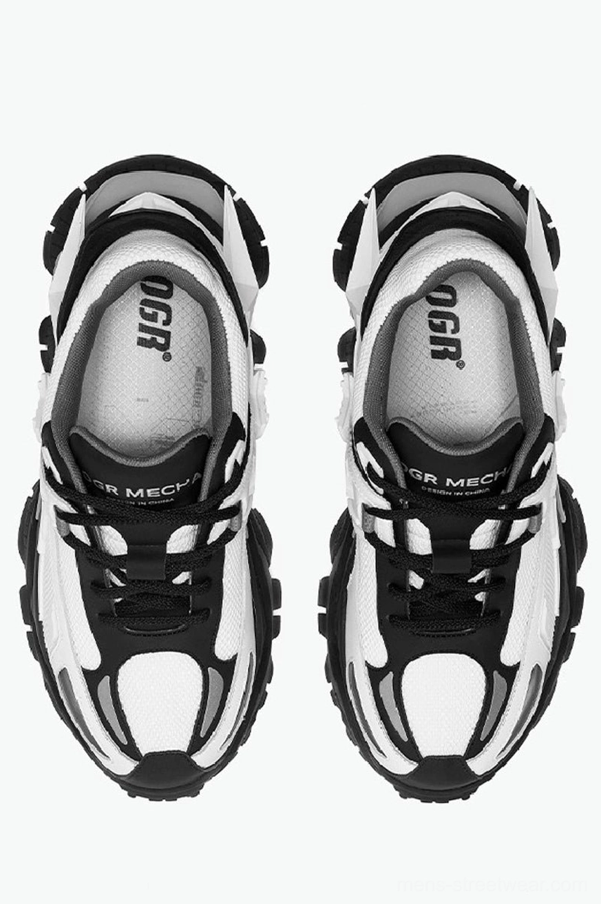 Top-down paired view of black and white mecha platform sneakers highlighting breathable mesh upper construction and bold futuristic silhouette