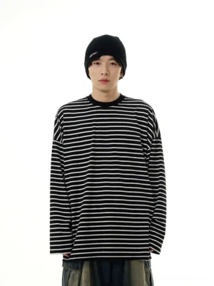 Front view of a black and white oversized striped long sleeve streetwear tee with dropped shoulders and relaxed crew neck fit