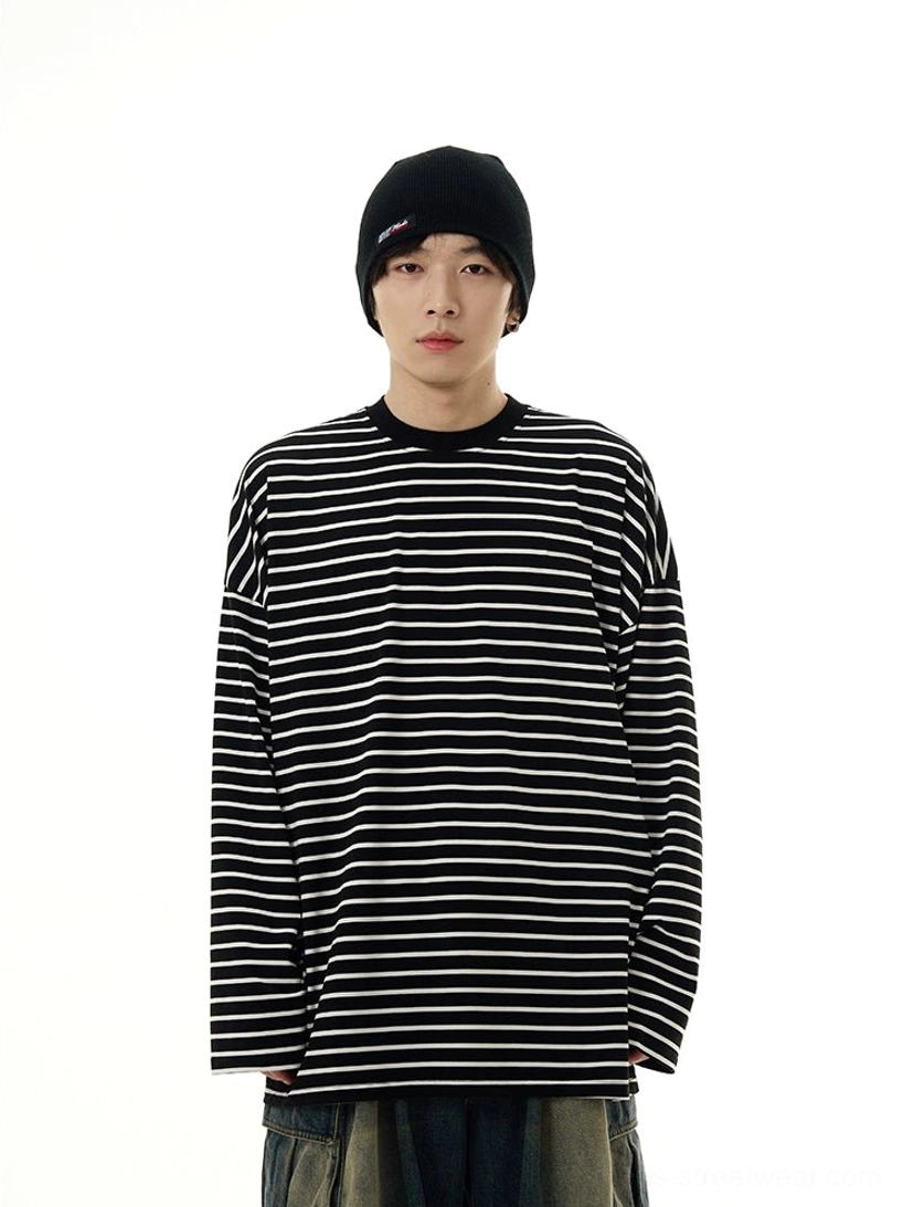 Front view of a black and white oversized striped long sleeve streetwear tee with dropped shoulders and relaxed crew neck fit