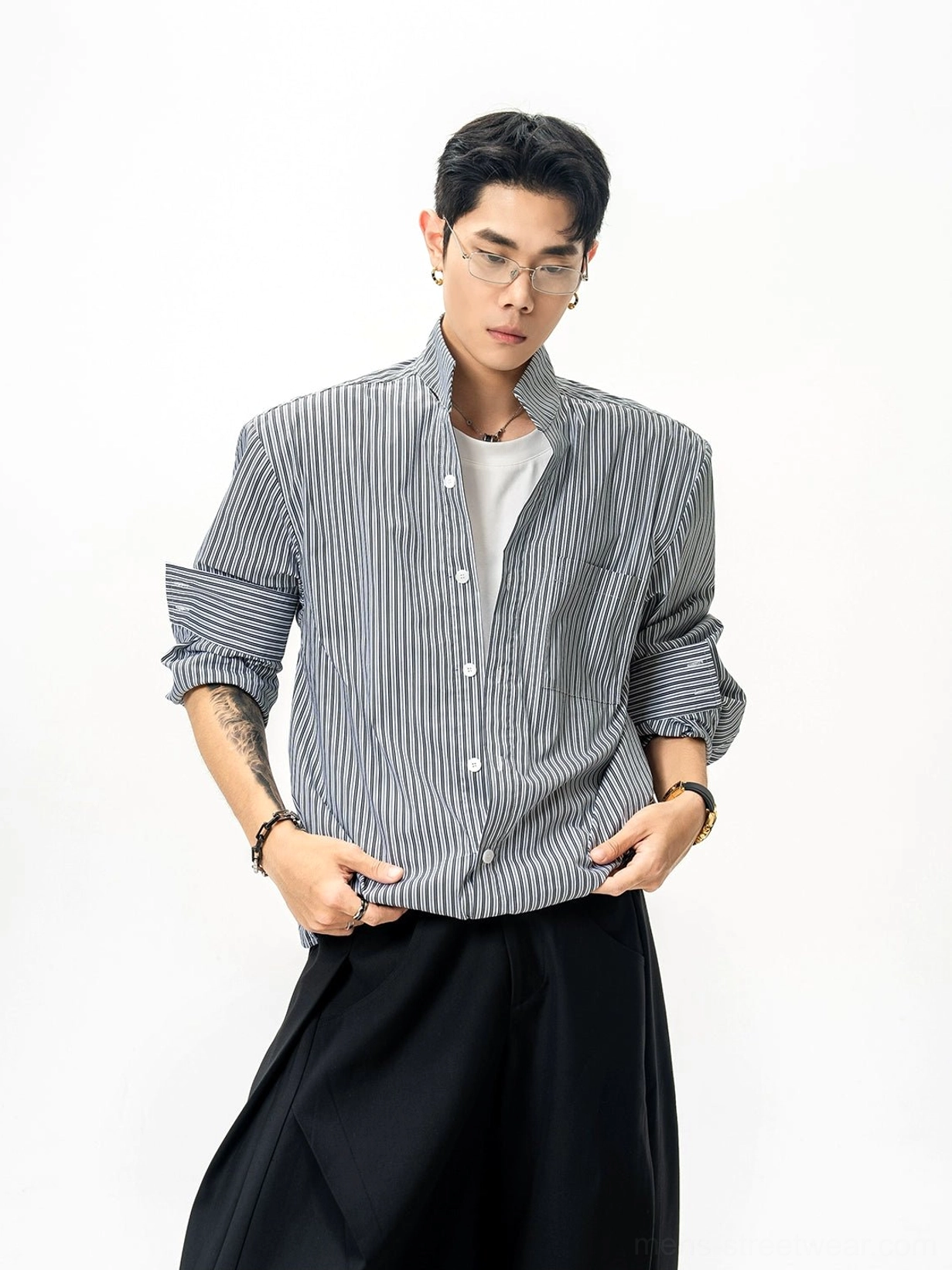 Black and white pinstripe stand collar shirt front three-quarter view featuring button closure and rolled cuffs