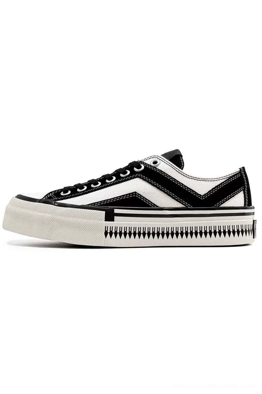 Side profile of black and white platform canvas sneaker with lace-up closure chevron stripes and thick off-white rubber sole
