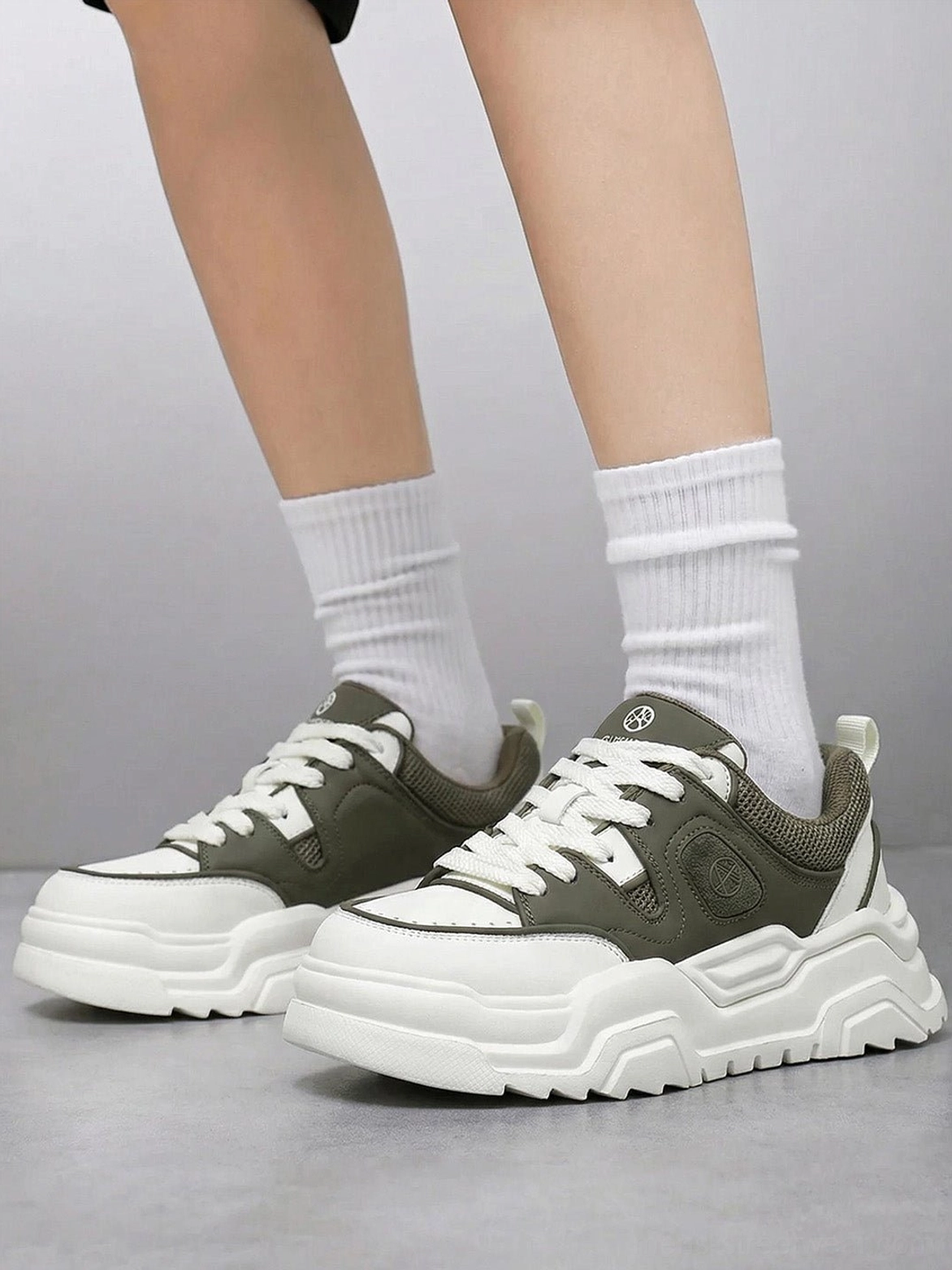 Black and white platform sneaker top-down view showing lace system eyelet placement and tongue geometry from overhead perspective