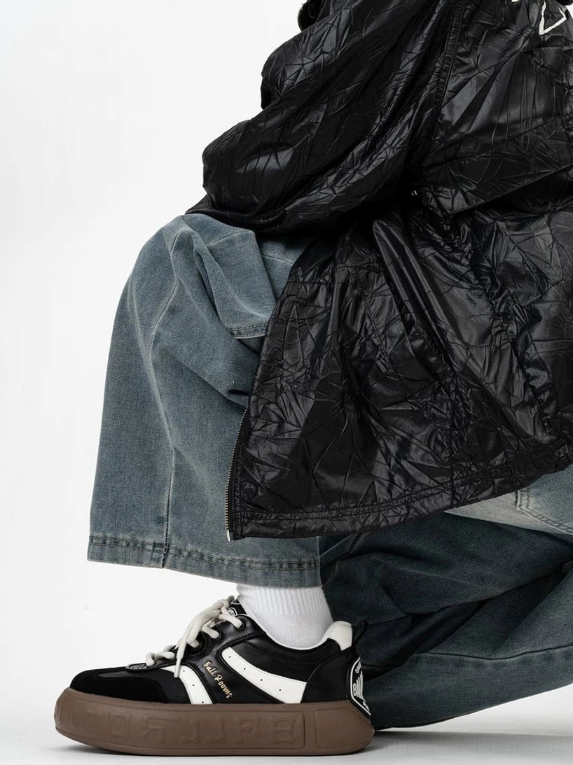 Black and white retro streetwear sneakers with contrast white accents branded heel tab and thick gum rubber outsole styled with baggy jeans