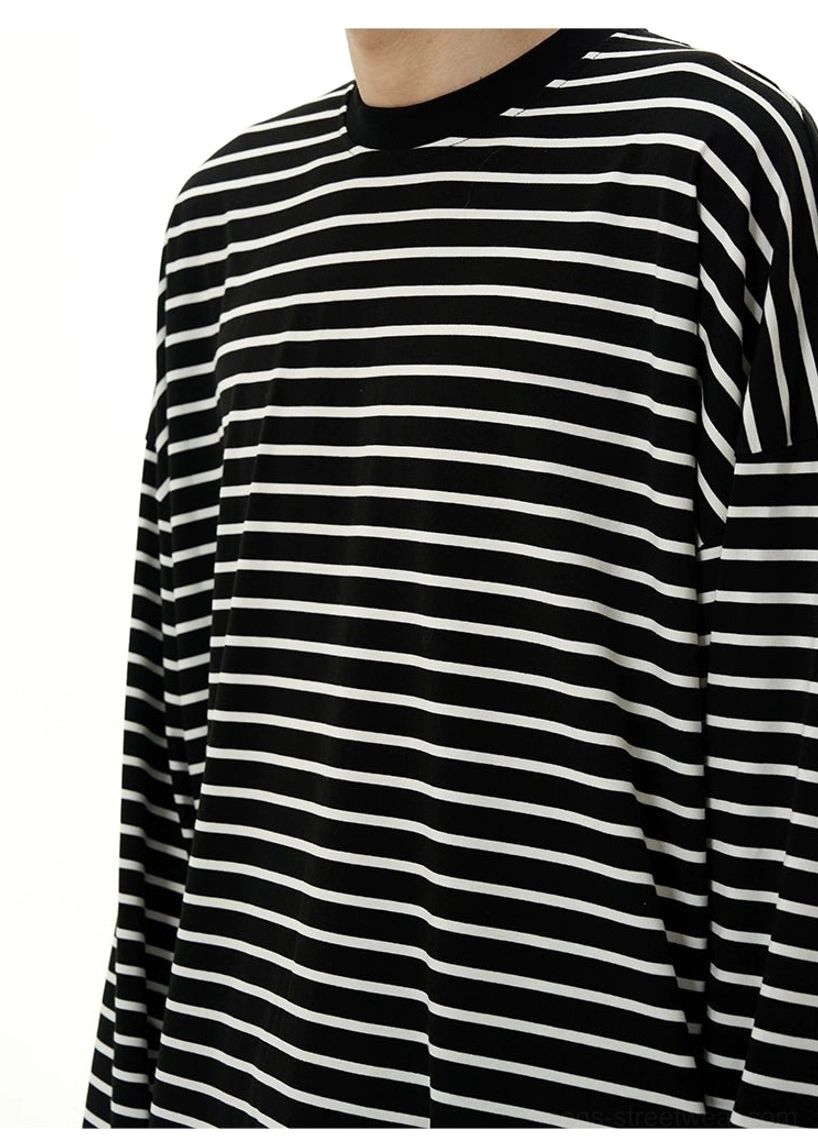Close-up of the crew neck binding and fine horizontal stripe texture on a black and white cotton street tee
