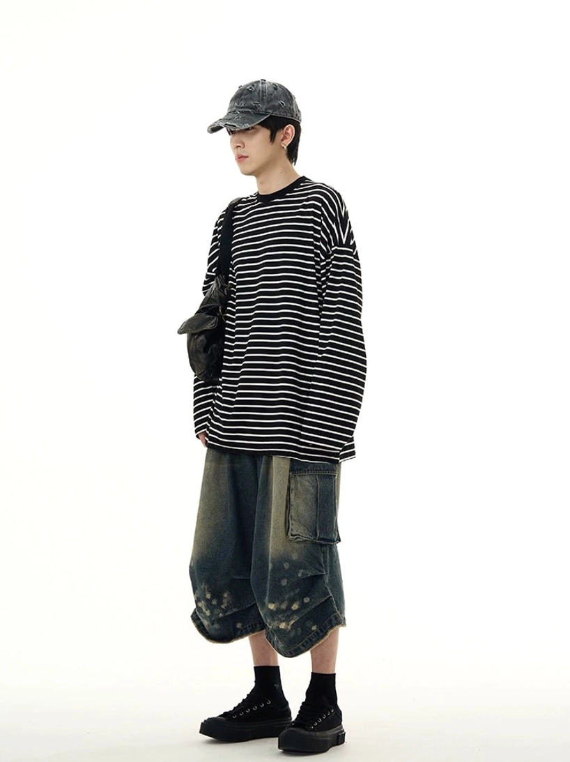 Left side view showing the loose drape and extended sleeves of a black and white striped streetwear tee