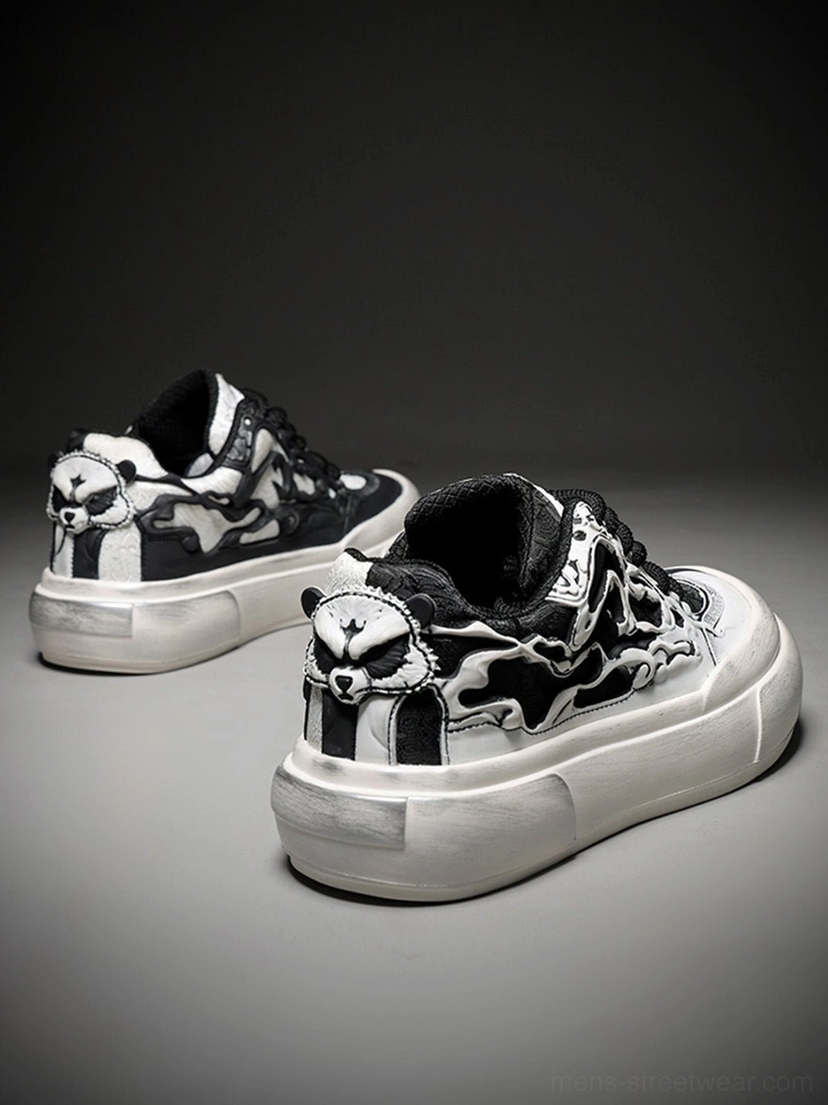 Rear angled view of black white Tai Chi panda chunky platform sneakers showing graphic heel details and matching thick off-white soles