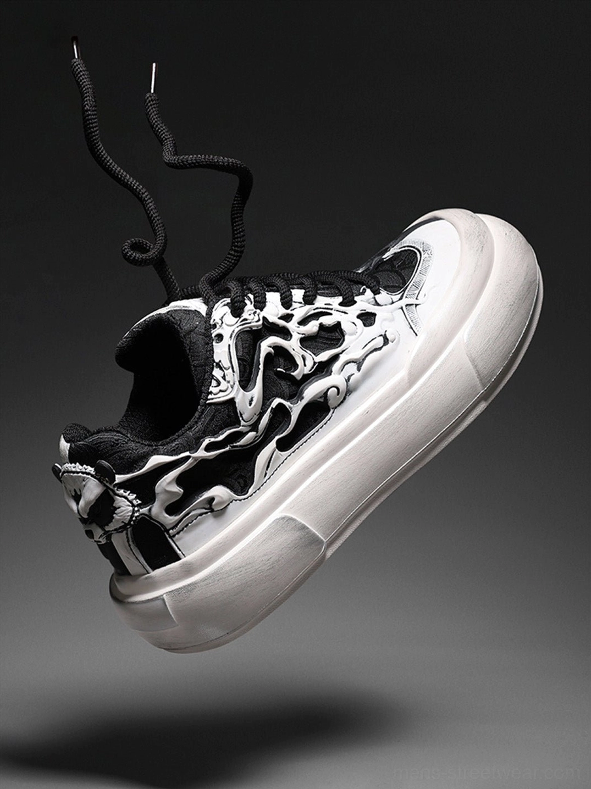 Close angled view of black white Tai Chi panda graphic sneaker showing textured printed upper, curled laces, and chunky platform sole
