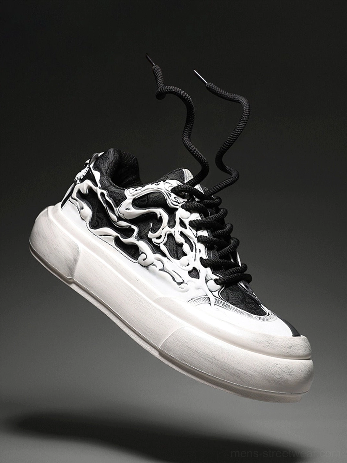 Low angle side view of black white Tai Chi panda platform sneaker with graphic artwork, loose laces, and oversized sole