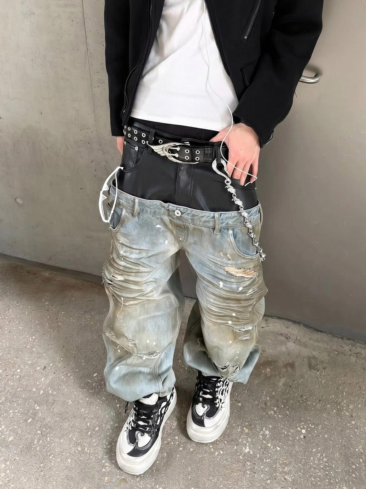 Black white Tai Chi panda platform sneakers styled with baggy faded jeans, black blazer, white top, and chain accessories