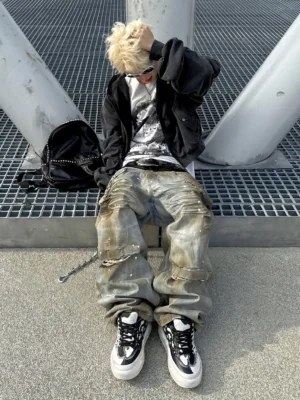 Black white Tai Chi panda platform sneakers worn with faded jeans and a cropped black streetwear jacket on an industrial platform
