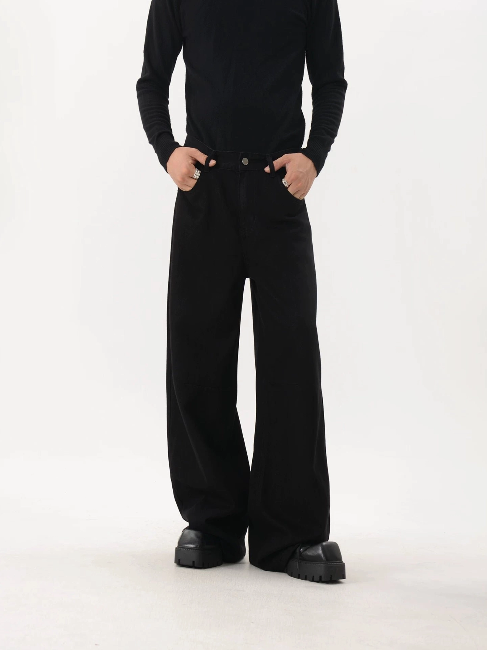 Full front view of black washed American retro wide-leg trousers with clean waistband, flowing long legs, and minimalist contemporary streetwear styling