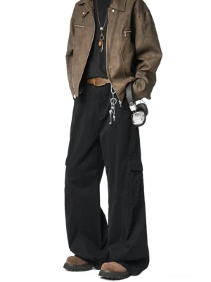 Black wide-leg cargo pants styled with a brown leather jacket, cargo pockets, oversized fit and urban streetwear accessories