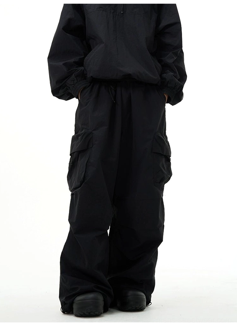 Full-body back view of black wide-leg cargo pants with elastic waistband and flap thigh pockets