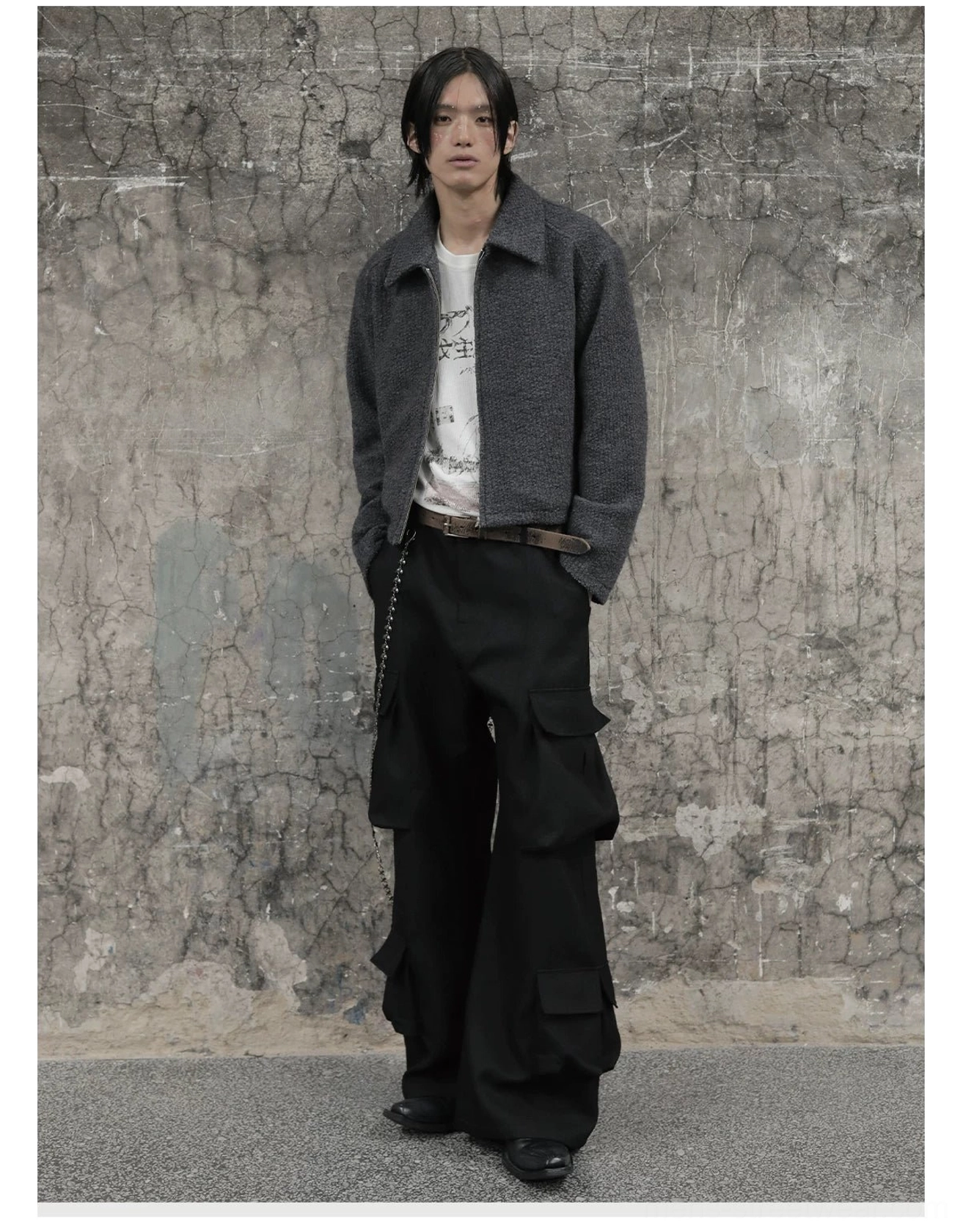 Front view of relaxed black wide-leg cargo trousers worn with a cropped blazer and graphic white tee