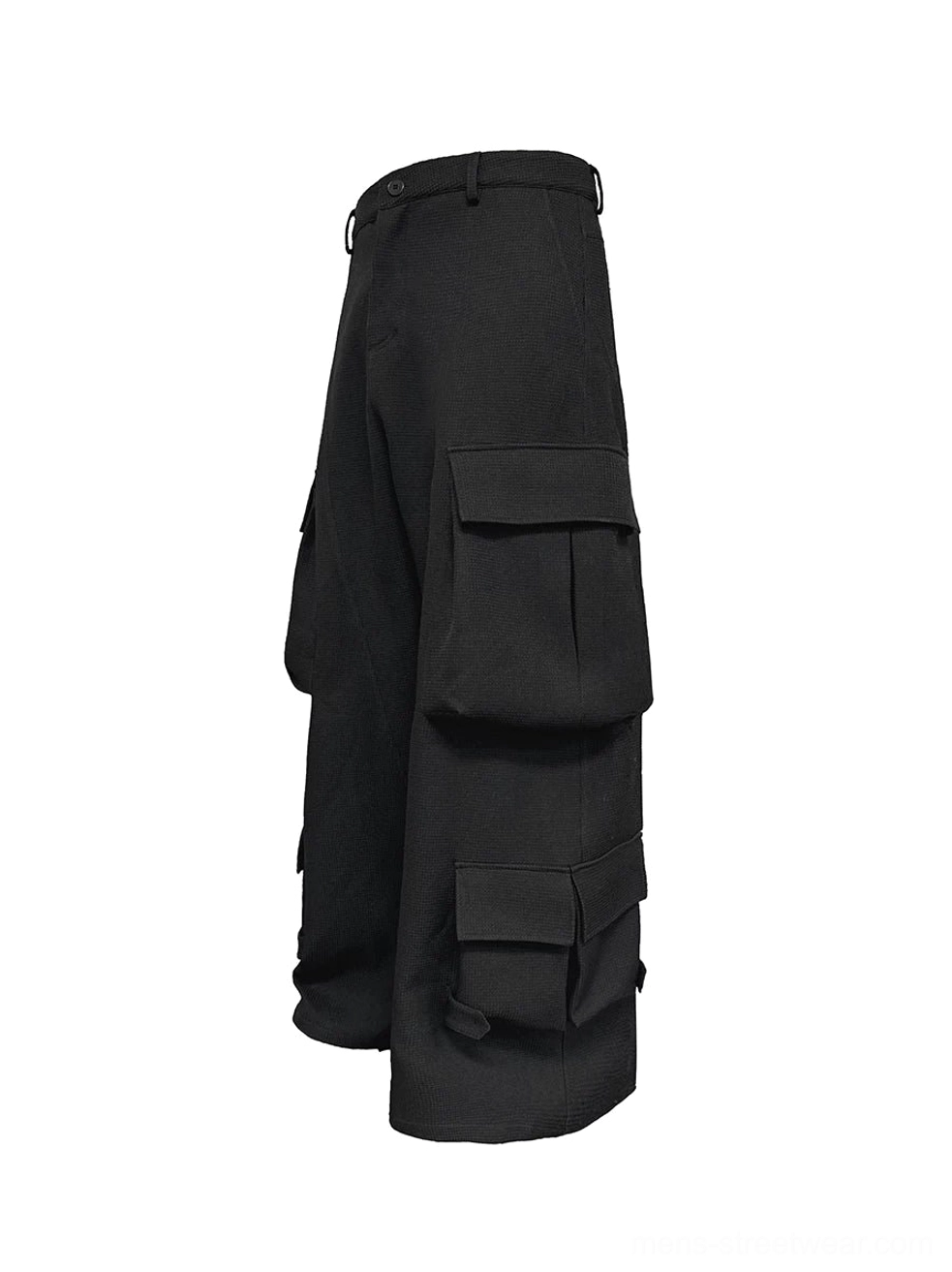 Side three-quarter view of black wide-leg cargo trousers showing stacked thigh and lower-leg flap pockets