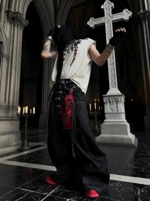 Black wide leg hook closure contrast stitch jeans back view styled with red waist bag in gothic church