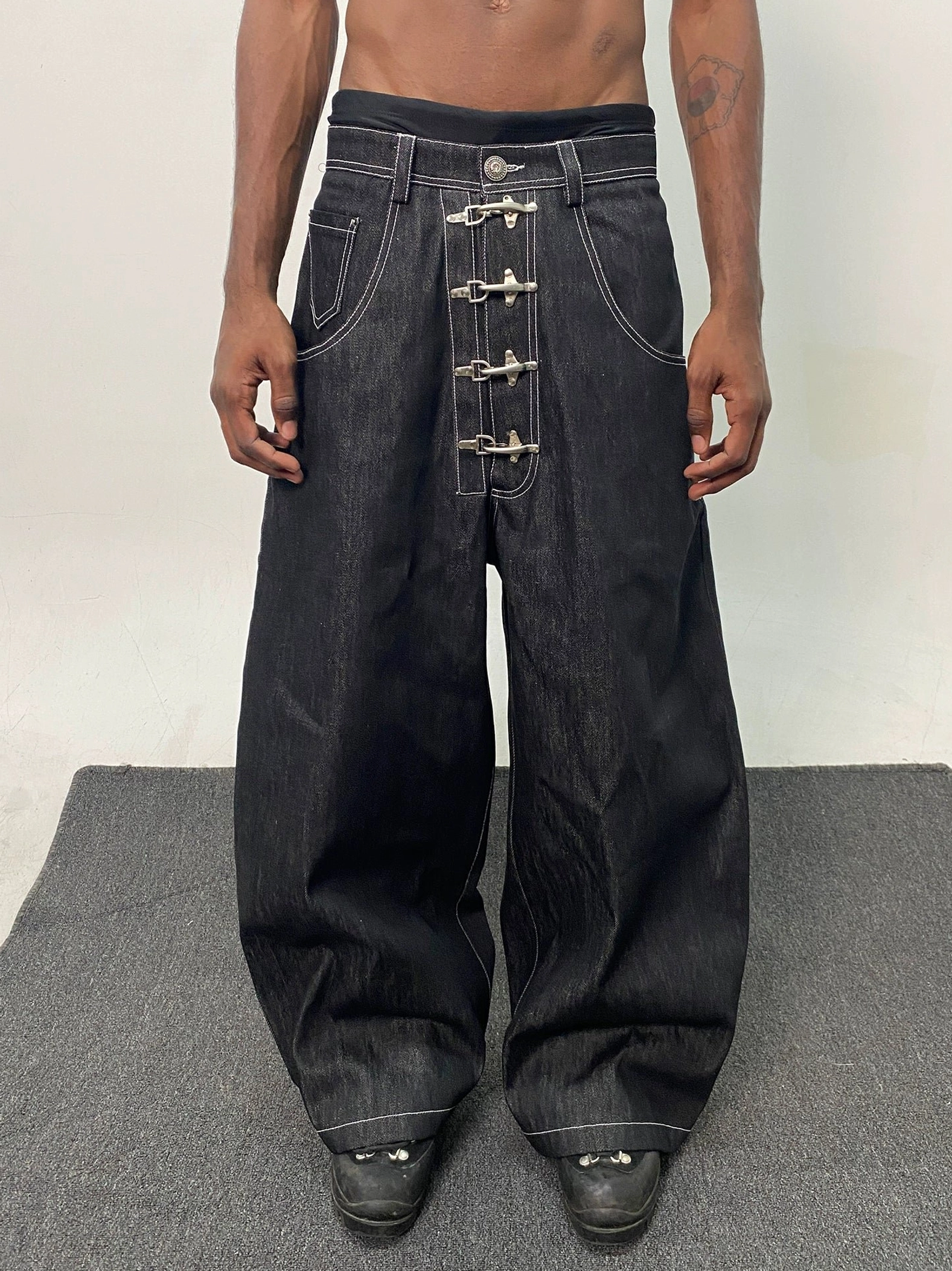 Black wide leg hook closure contrast stitch jeans front product view on grey background